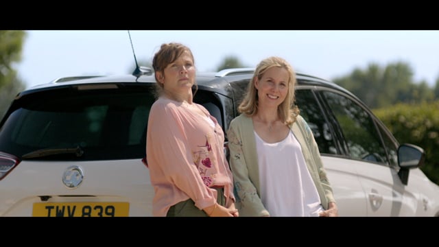 Two women by a white Vauxhall Crossland X